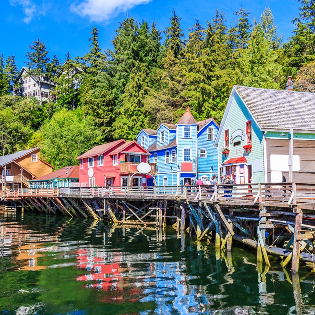 Green trees and colorful buildings of Ketchikan, Alaska. Click to book a 7-day inside passage roundtrip vancouver cruise.
